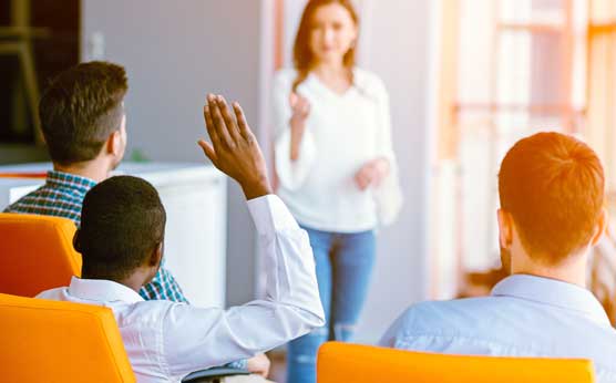 Teacher in front of a group of adult learners