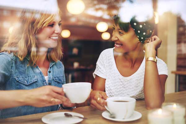 Two friends chatting in a cafe