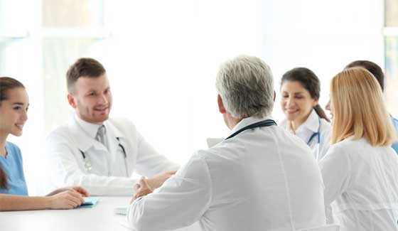 Group of medical professionals around a table