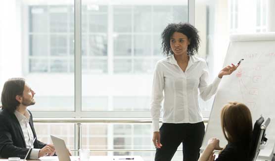 Woman addressing a business meeting